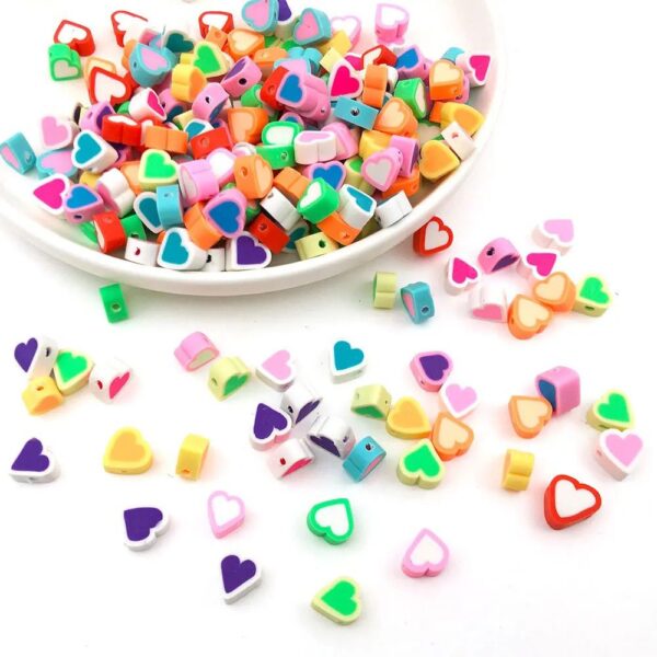 70010-2 - Tira de pucca/fimo corazones de colores