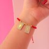 41168 - Pulsera roja balines escapulario mano / rayo